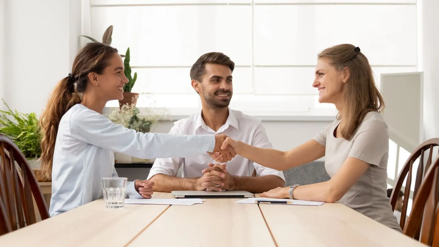 happy-female-business-partners-handshake-sign-contracts-with-lawyer-mediation